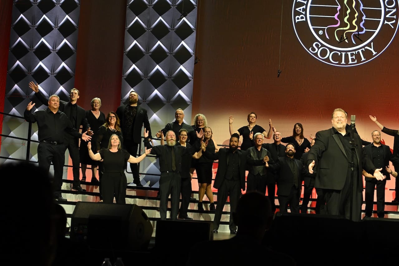 Voices Unlimited - Denver 2025 An all-voices barbershop chorus (Voices Unlimited) performing on stage.